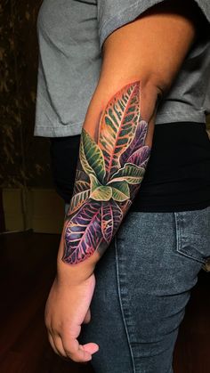 a woman's arm with a colorful tattoo design on the left forearm and wrist