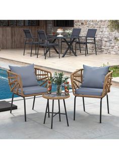 two chairs and a table near a pool