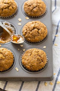 a muffin tin filled with cupcakes on top of a blue and white towel