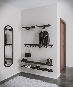 there is a coat rack and shoes on the wall