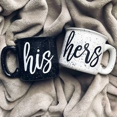 two black and white coffee mugs with the words his and hers painted on them