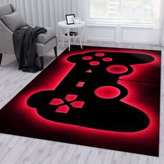 a living room area rug with a video game controller on the floor and red lighting