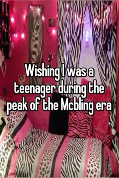 a bed with zebra print sheets and pink lights