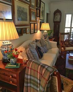 a living room filled with furniture and pictures on the wall