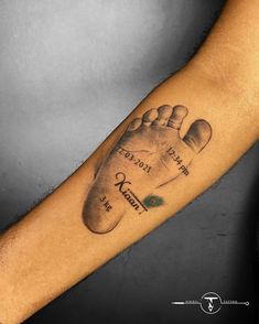 a man's arm with a tattoo on it that has a hand and foot