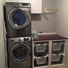 a washer and dryer in a laundry room with baskets under the front door