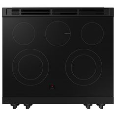 a black electric stove with four burners