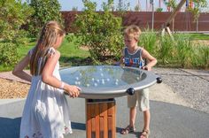 two children are playing with a glass table