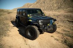 a black jeep is parked in the desert