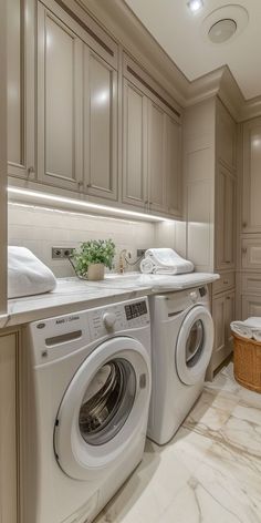 a washer and dryer in a very nice looking room with marble flooring