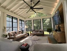 a living room filled with furniture and lots of windows