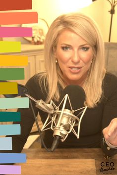 a woman sitting at a table with a microphone in front of her and the words ced behind her