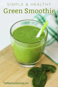 a green smoothie is in a glass on a cutting board with the words, simple & healthy green smoothie