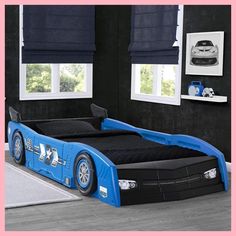 a blue race car bed with black sheets