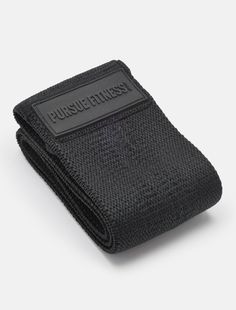 a black pouch with the word pursuitness on it and a white tag hanging from the front