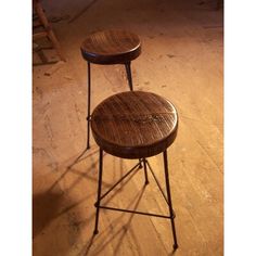 two stools sitting on top of a hard wood floor next to each other in a room