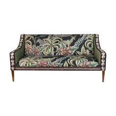 a green and black couch with floral designs on the back, sitting in front of a white background