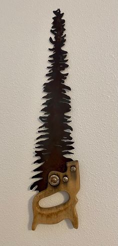 a piece of art that looks like a tree with scissors hanging from it's side