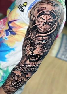 a man's arm with a clock and lion tattoo on the left side of his arm