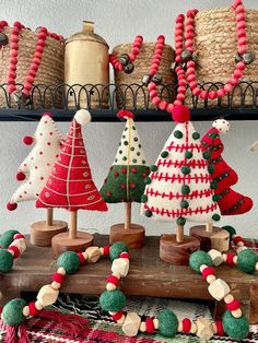 some christmas trees are on display in a room with baskets and other items behind them