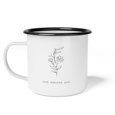 a white and black coffee mug with the words god adores you on it