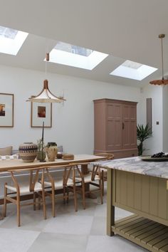 a kitchen with an island and skylights in it's rooflight area is shown