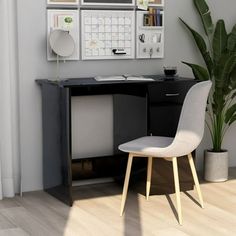 a desk with a chair next to it and a calendar on the wall behind it