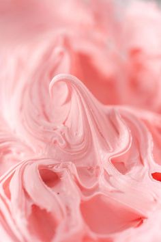 a close up view of some pink icing