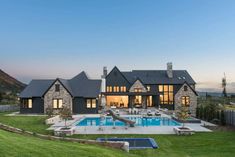 a large house with a pool in front of it