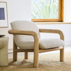 a chair sitting on top of a rug next to a window