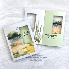 two cards with watercolor paintings on them, one is green and the other is white