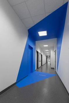 an empty hallway with blue and white walls