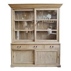 an old wooden china cabinet with glass doors on the front and drawers in the back