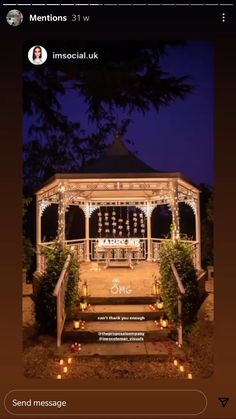 the gazebo is decorated with lights and candles for an outdoor wedding ceremony at night