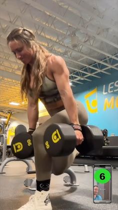 a woman squatting on a bench with dumbbells in the foreground and an image of a man behind her