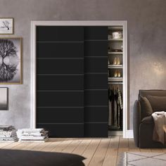 a living room filled with furniture and a black sliding door that opens to a walk in closet