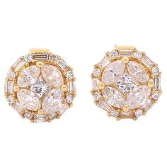 These 18K solid yellow gold natural diamond cluster earrings feature a total of 0.72 carats in mixed cut diamonds. Each earring measures 7.7mm in diameter and features a central princess-cut diamond, framed by four oval-cut diamonds, and further enhanced by a round and baguette-cut diamond halo set in a round illusion setting which offers the optics of a larger single center stone. All the look for a fraction of the price. Mounted with a strong 18k gold butterfly push-back closure. Gold purity s Diamond Pendants Designs, Diamond Cluster Earrings, Round Stud Earrings, Baguette Cut Diamond, Oval Cut Diamond, Gold Butterfly, Cluster Earrings, Pendant Design, Diamond Cluster