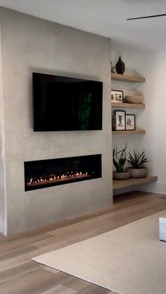 a television mounted on the wall above a fireplace