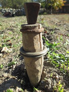 an old wooden post in the middle of a field