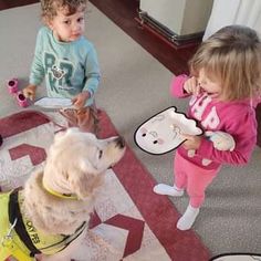 two children and a dog playing with toys