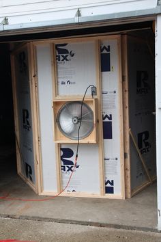 an air conditioner in the back of a building being built with plywood framing