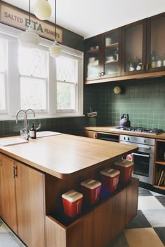 a kitchen with wooden cabinets and green tile flooring