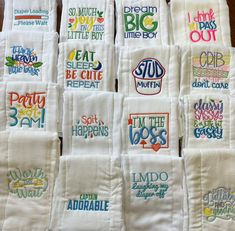 many hand embroidered tea towels are stacked on top of each other