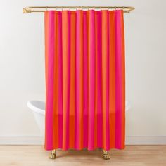 an orange and pink shower curtain in a bathroom