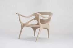 a chair made out of wood sitting on top of a white floor