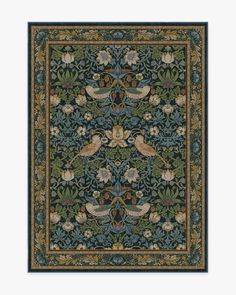 an intricately designed rug with birds and flowers in blue, green, yellow and brown colors