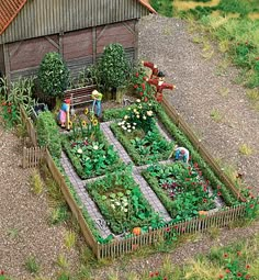 an aerial view of a garden with people working in it