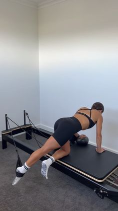 a woman is doing an exercise on a treadmill