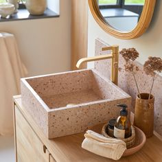 a bathroom sink sitting on top of a wooden counter