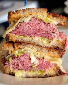 a close up of a sandwich on a plate with a toothpick in it